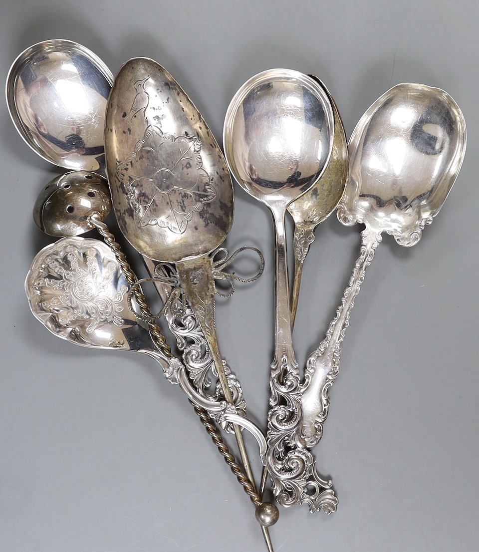 Three 20th century Scandinavian 830 standard white metal ornate spoons, a sterling spoon and three other spoons.